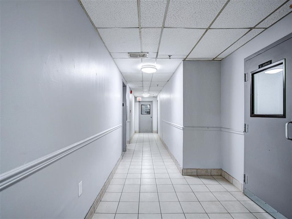 Well-lighted, interior of 2740 Jane apartment building hallway.