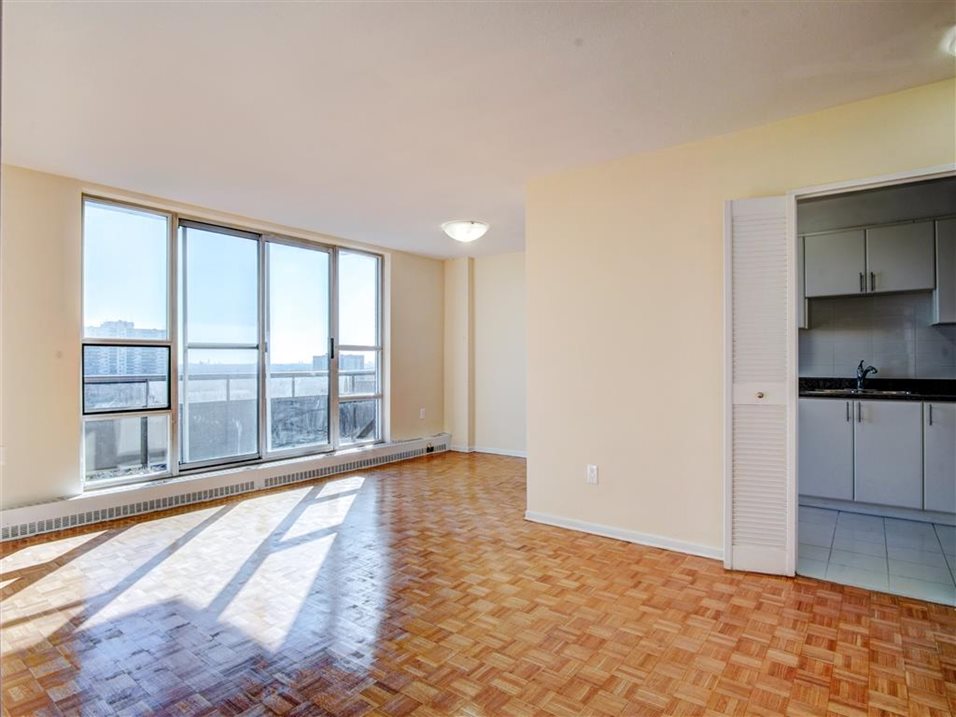 Living areas inside a 2740 Jane apartment, with view of balcony overlooking the community.